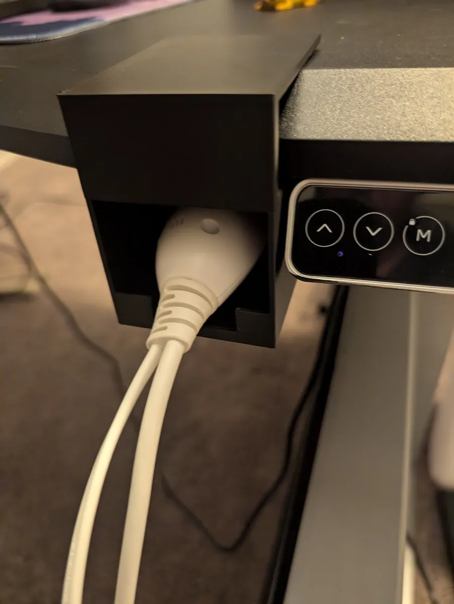 The finished holder mounted under the desk with the remote inside